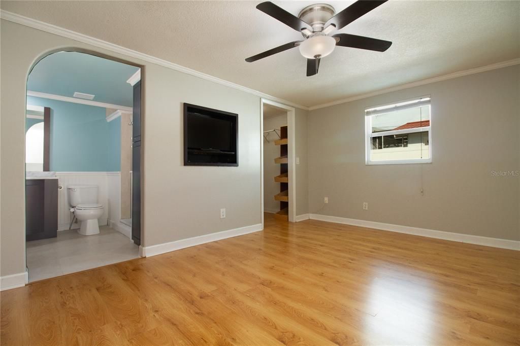 Primary bedroom showing bathroom and walk in closet