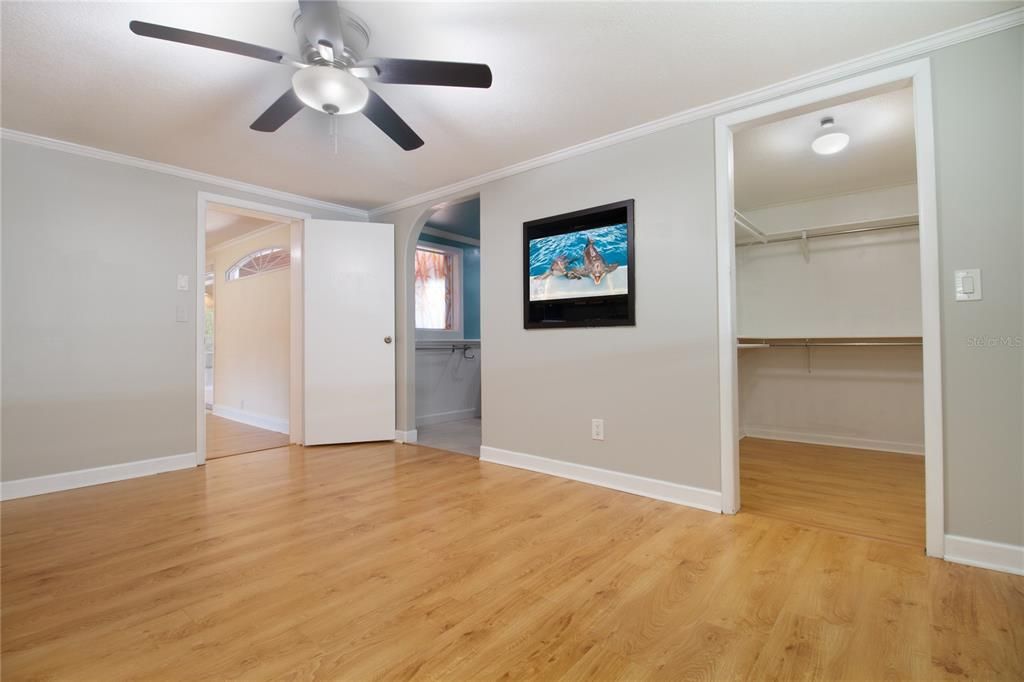 primary bedroom showing bathroom and walk in closet