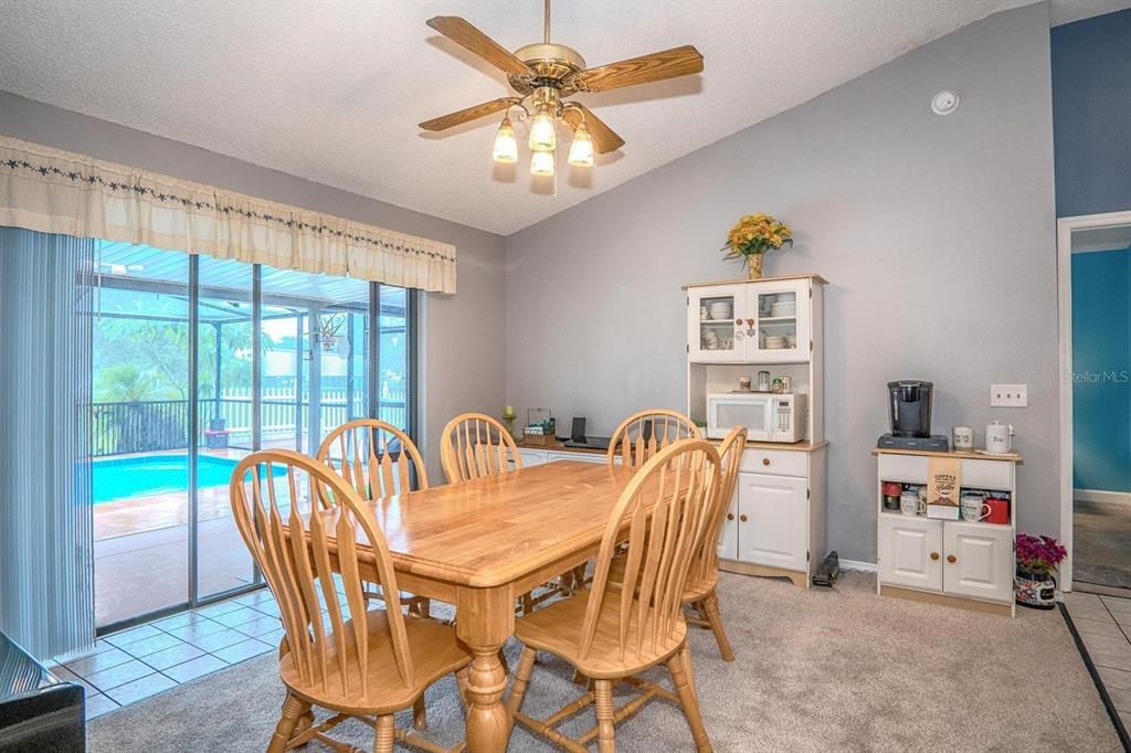 Dining room with sliders to the porch and pool