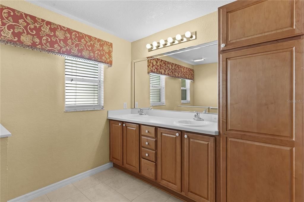 Dual vanity and large linen storage in primary bath