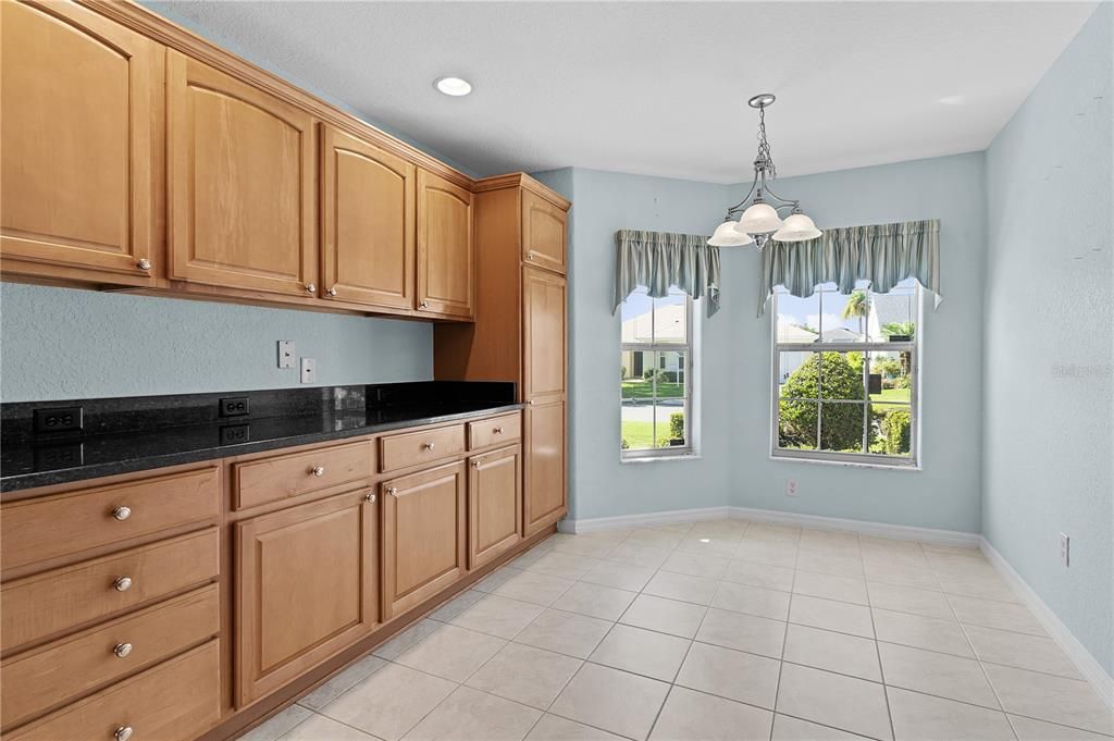 Stretched cabinets with tall pantry cabinet