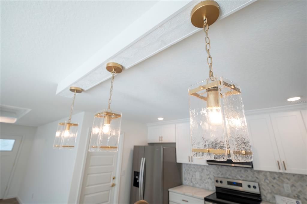 Love the gold finished pendant lights above the island