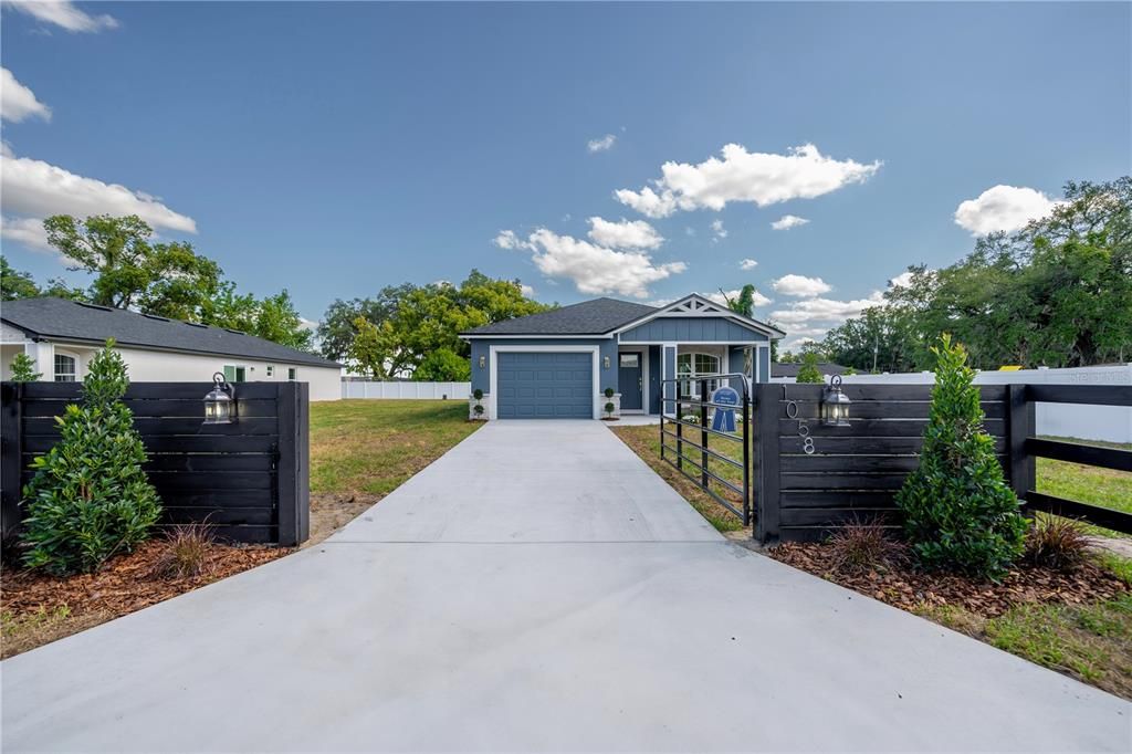 Nice long driveway leading to your 1 car garage with garage door opener