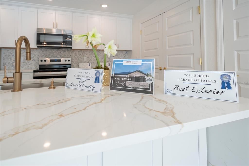 Look at the beautiful gold fixtures that coordinate with the gold in the countertops.