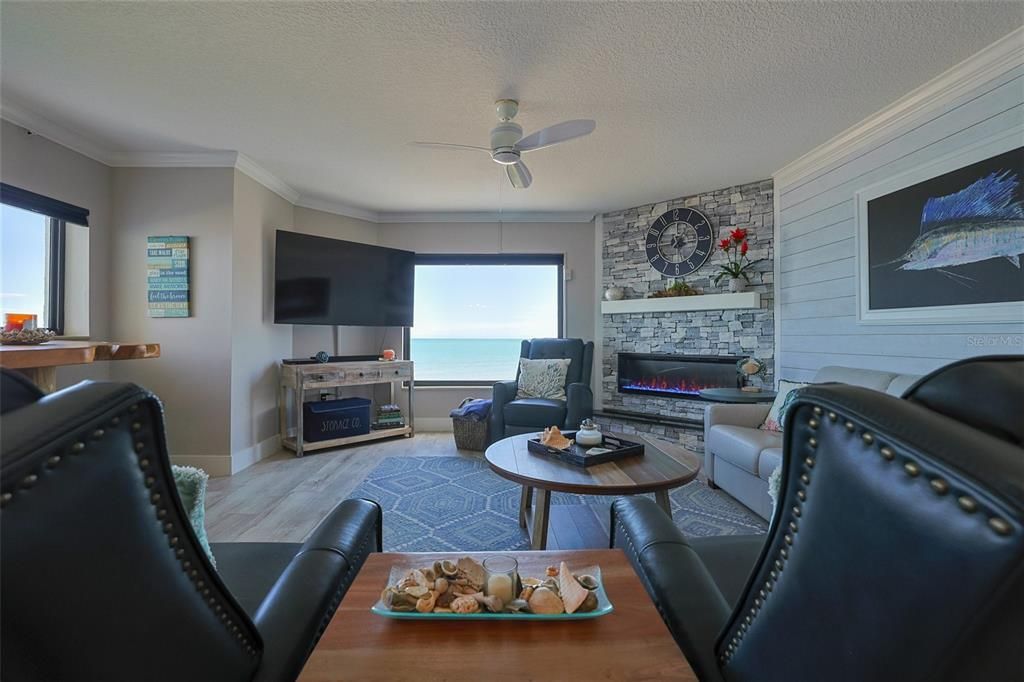 Oceanfront Windows and electric fireplace warm up the space