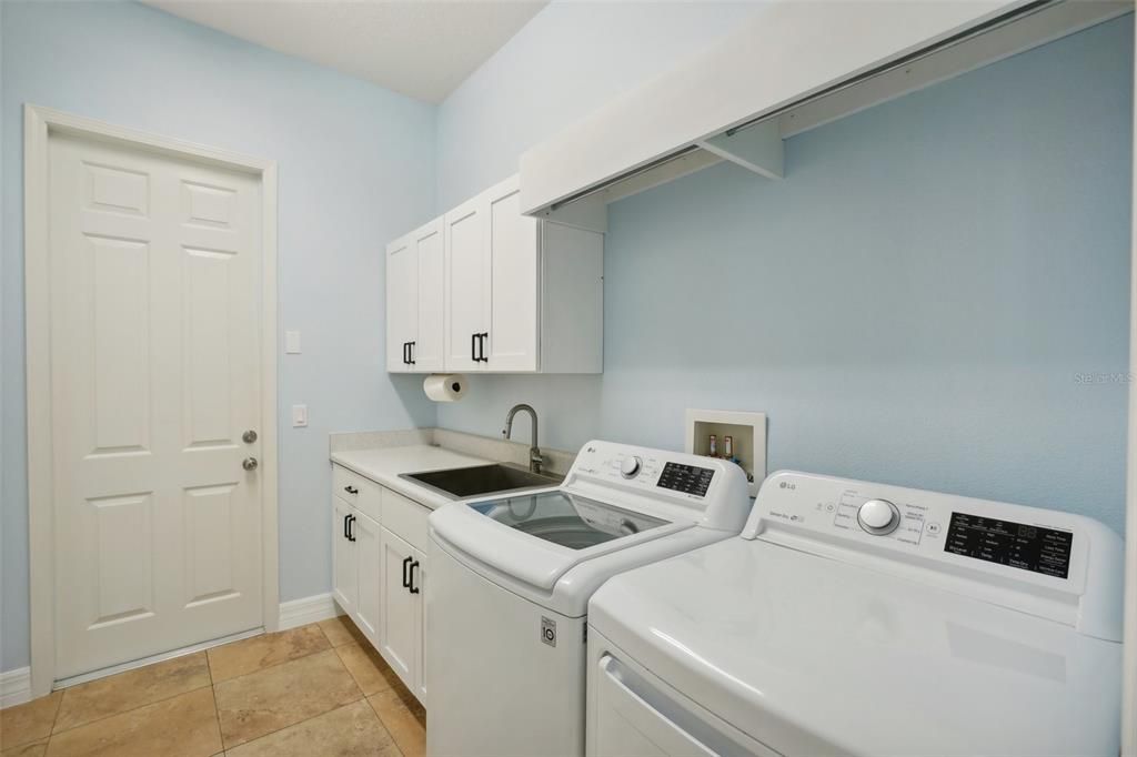 laundry room is located on the first floor by the primary bedroom