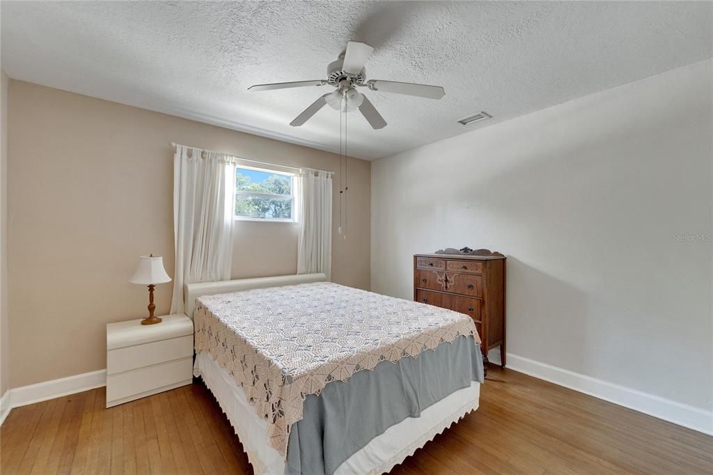 Bedroom 2 also features original hardwood floors