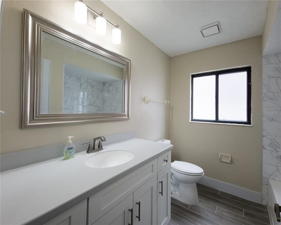 Guest bathroom featuring modern fixtures.