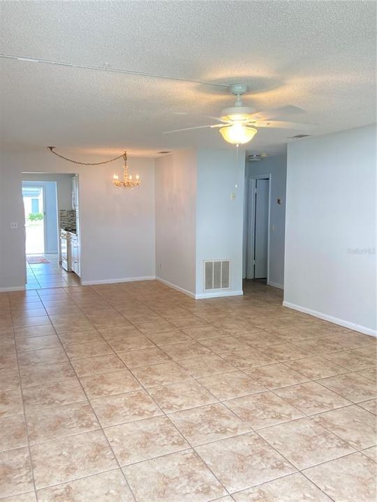 Dining area to kitchen and back door, hall to bedrooms on the right