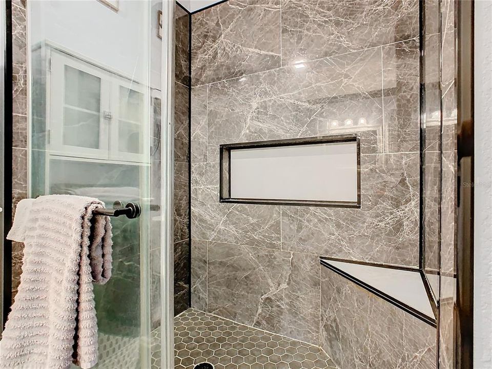 Primary bathroom has walk-in shower and built in seat