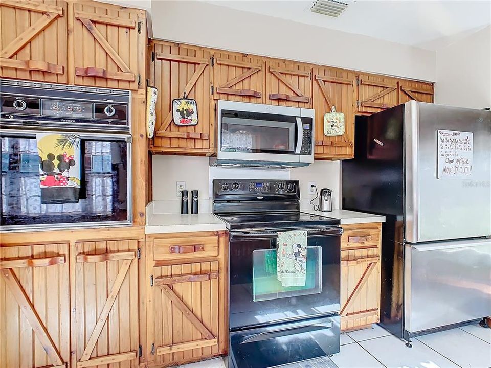 Kitchen has stainless steel appliances and wood cabinets