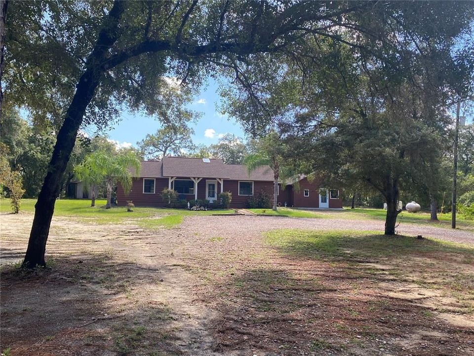 Come enjoy the peace and tranquility of this 5+ acre property located in Tiger Creek Forrest – a horse friendly, gated community with an abundance of wildlife.