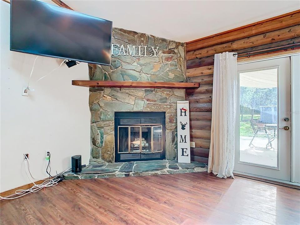 There is a cozy fireplace in the living room and French doors that provide a view of the back-yard patio and pool area - a perfect space for relaxing and entertaining family and friends.