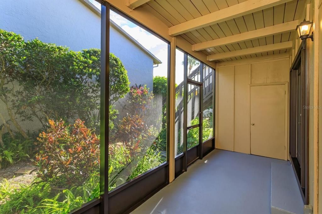 screened patio with landscaping outside