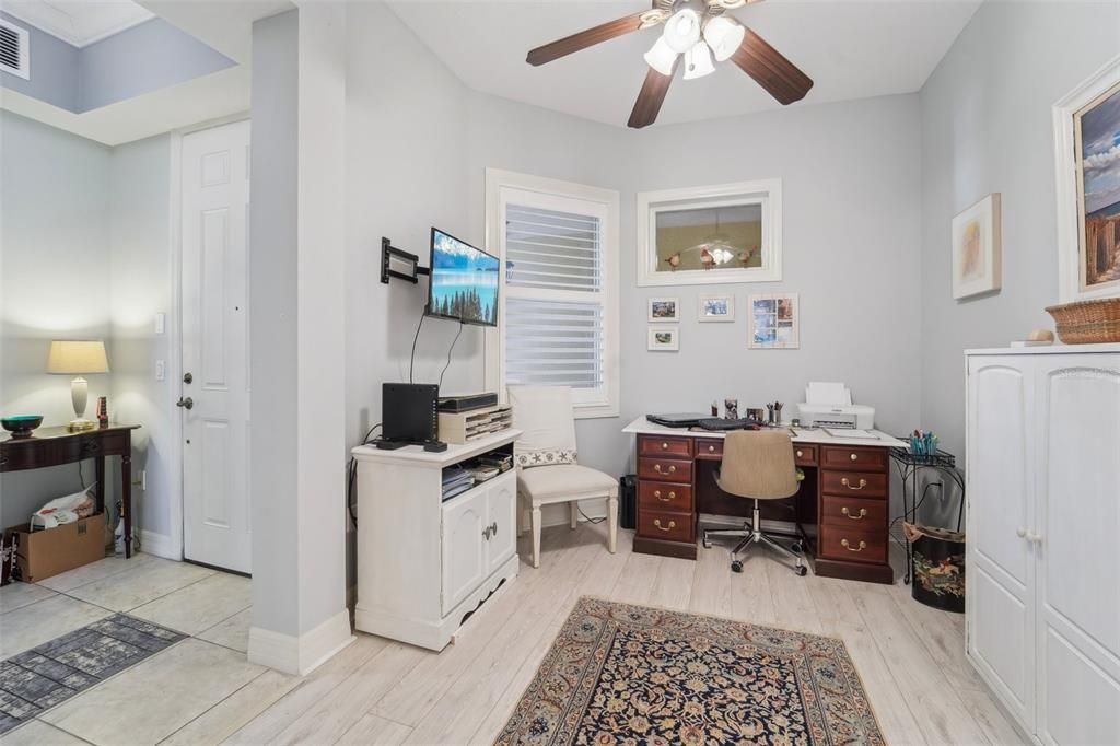 Office/Flex Room with wood laminate flooring off the Foyer and Kitchen