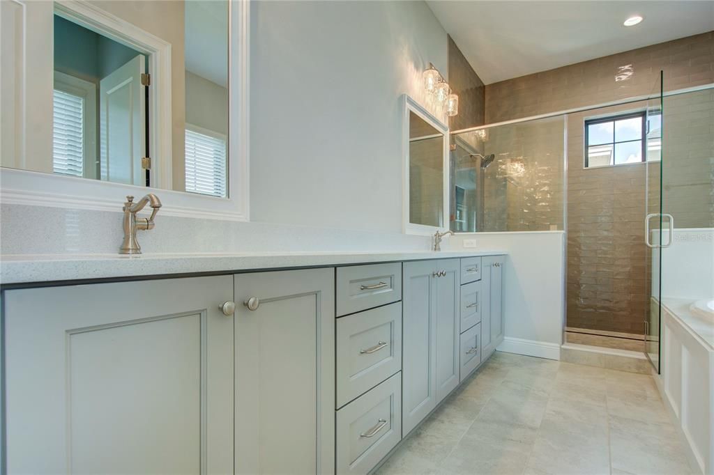 Master Bath with dual sinks, water closet and separate tub and shower