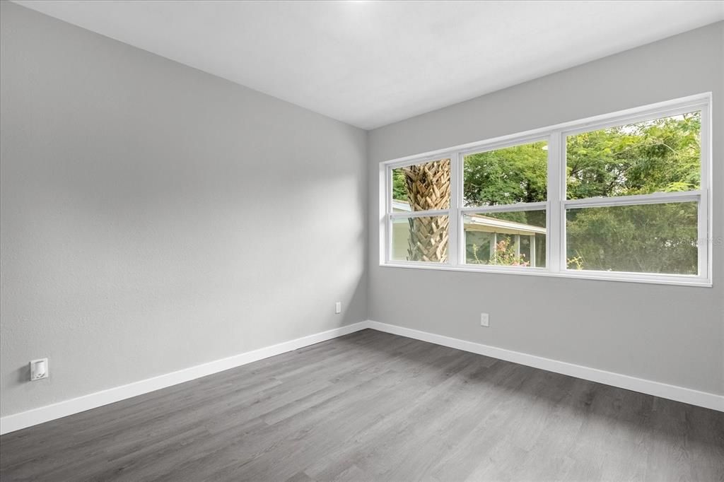 master bedtroom big windows overlooking the backyard.