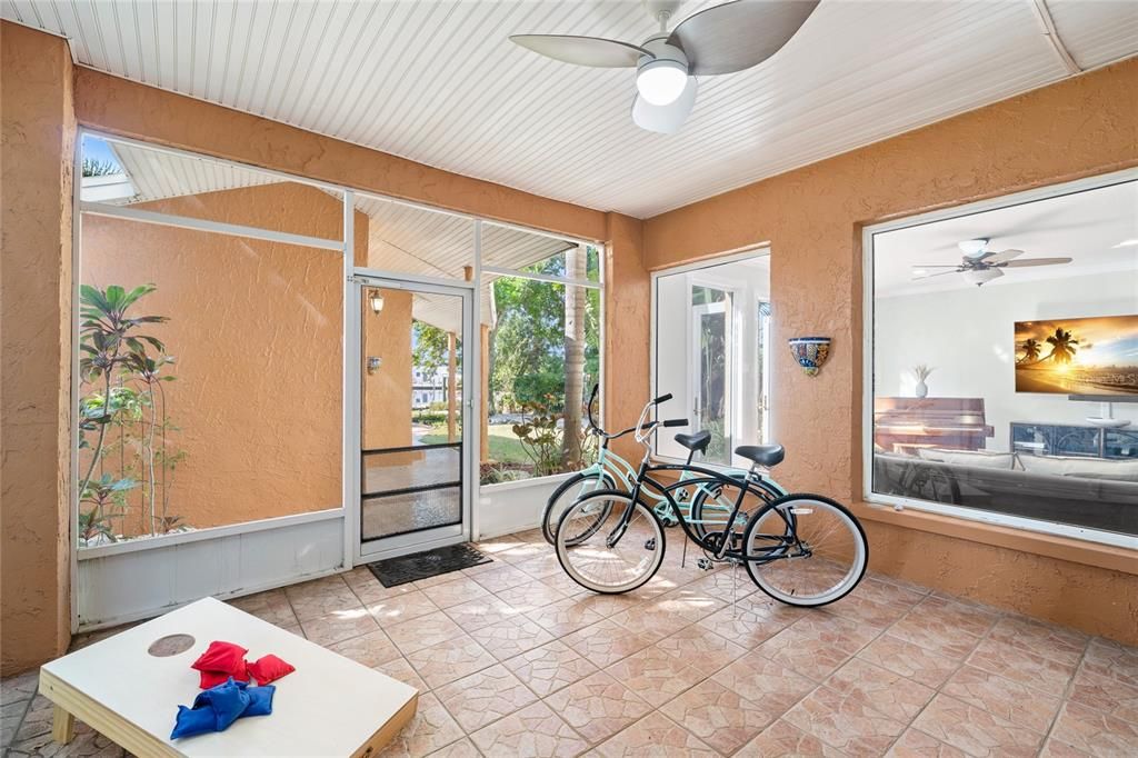 Enclosed Patio with Bikes, Ping Pong Table, and Yard Games.