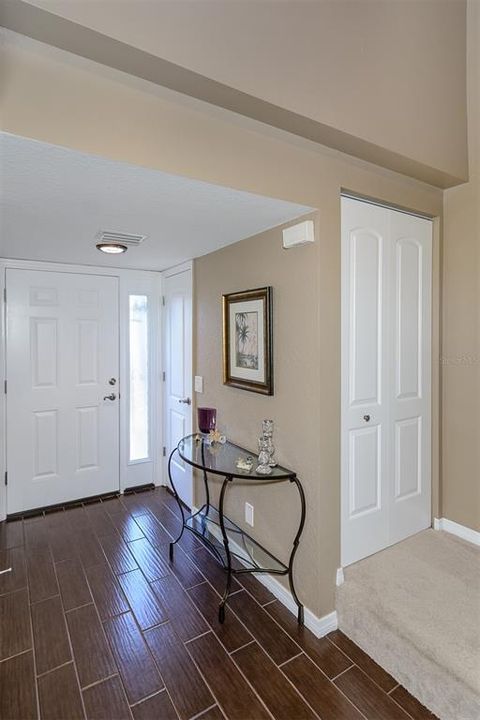 Inside front entry, door to the powder room to the right. closet door on the step up.