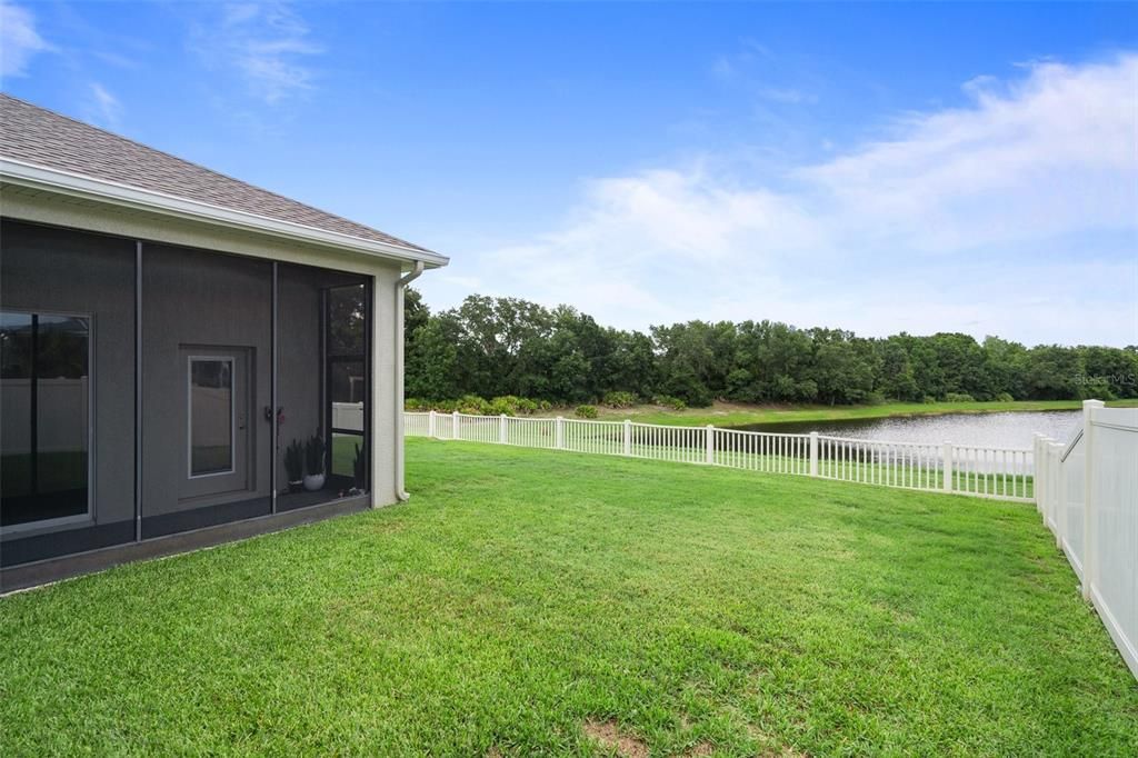 Spacious Yard with Tranquil Pond View and Vinyl Fenced Yard