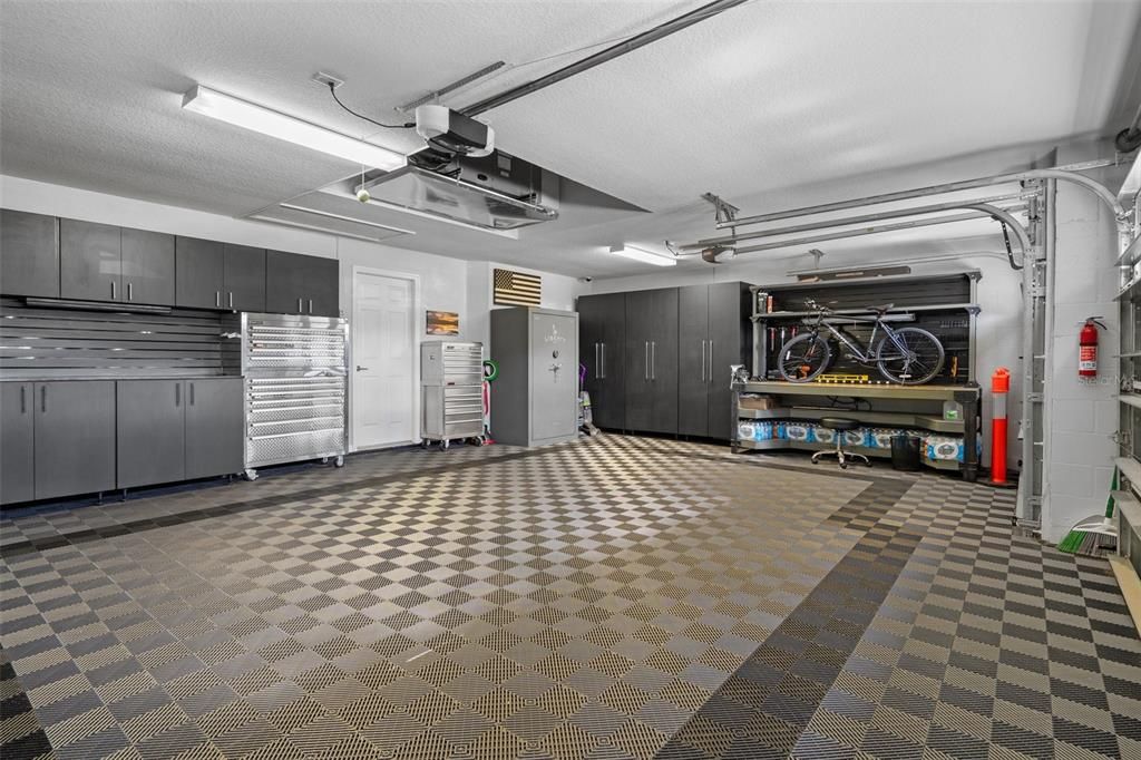 3 Car Garage with Decorative Interlocking Tile Floor, Safe, and Custom Cabinets