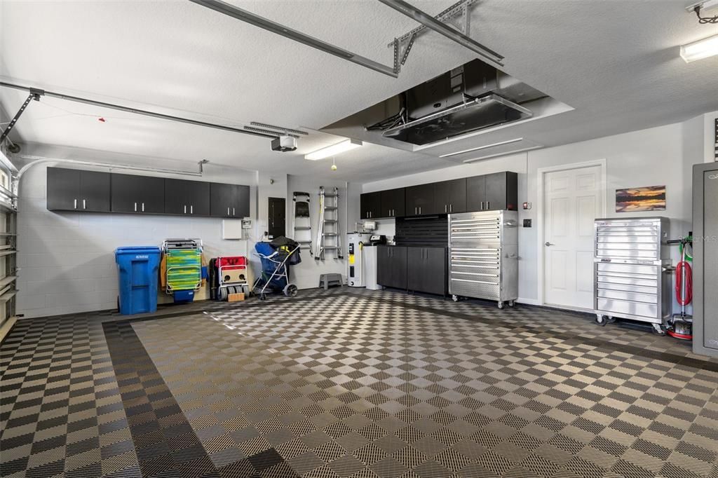 3 Car Garage with Custom Cabinets and Decorative Interlocking Tile Floor