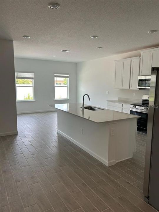 Kitchen with quartz countertops and stainless steel appliances