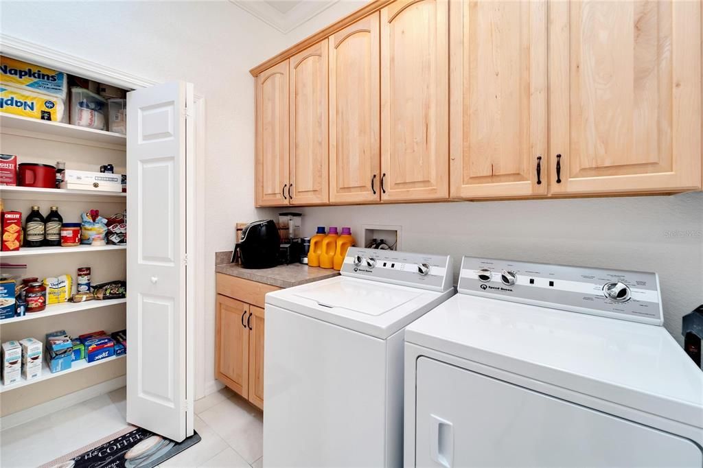 laundry room has large pantry and cabinets