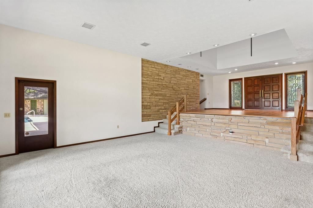 Family room features beautiful stacked stone accent walls and access to the lanai!