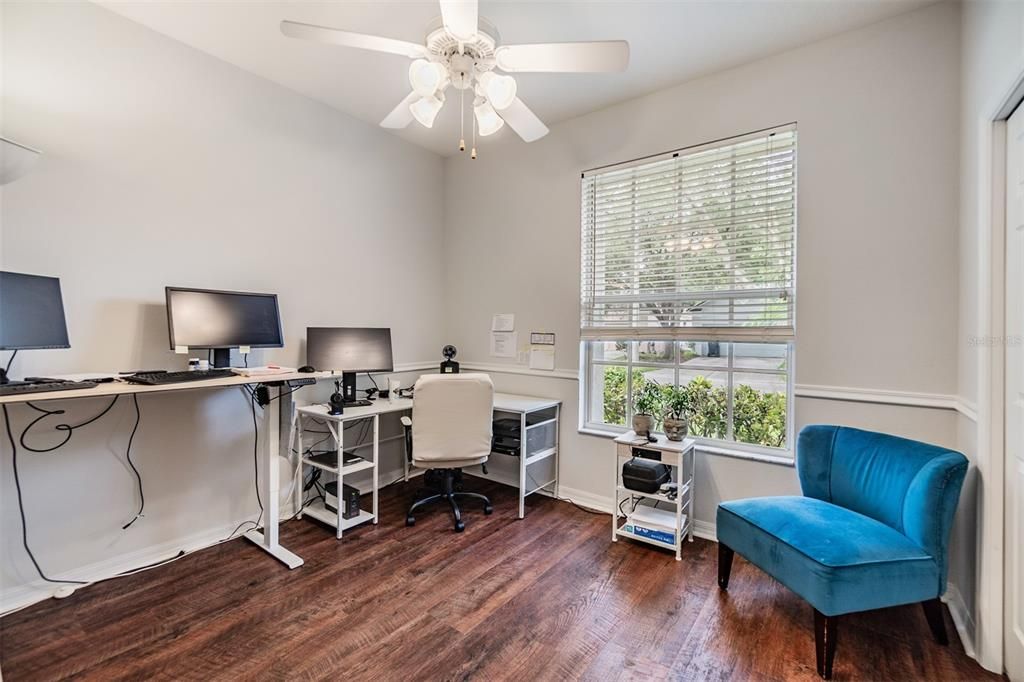 Guest Bedroom ( owners use as a front office). New Flooring and ceiling fan with lights.