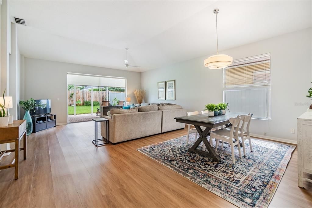 Large and Open Family room with New Vinyl Luxury Plank Flooring, Ceiling Fan and lots of sunlight.