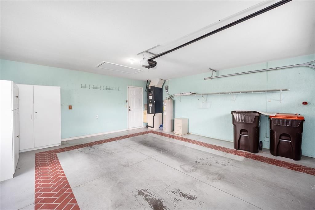 View from Overhead door to Laundry Room entrance door. Pull down attic access.