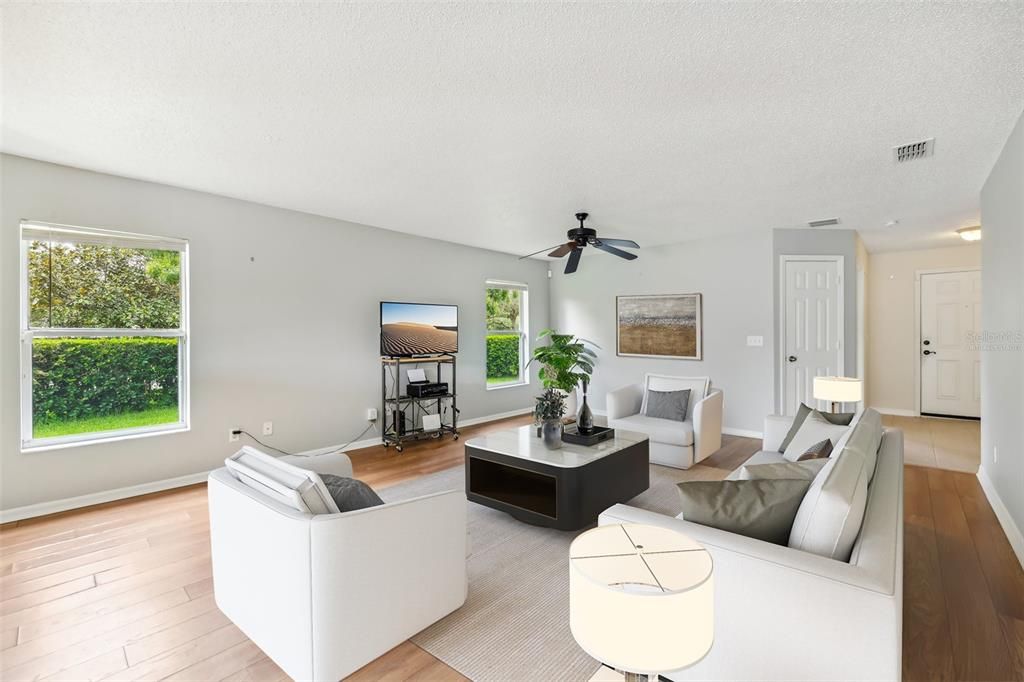 The foyer opens up to a light and bright living space with WOOD LAMINATE FLOORS for easy maintenance and twin windows that overlook your side yard. Virtually Staged.