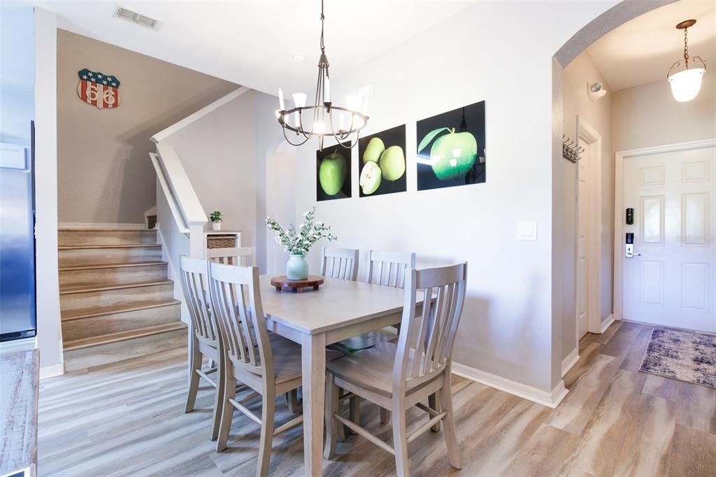 The living and dining areas are light and bright with WOOD LAMINATE FLOORS and sliding glass doors out to the covered lanai.