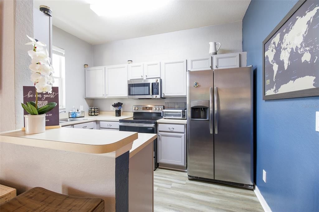 A breakfast bar for casual dining connects the space to the kitchen delivering a comfortable layout, STAINLESS STEEL APPLIANCES and pantry storage.