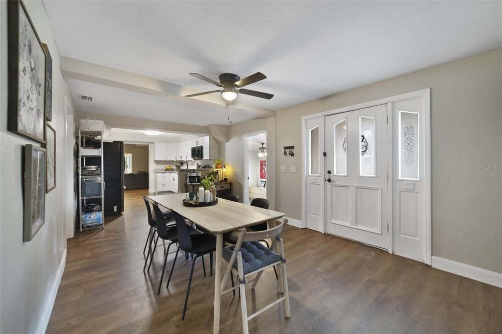 Step through the front door from a covered porch and into a spacious dining room that flows naturally into the kitchen and living room beyond.