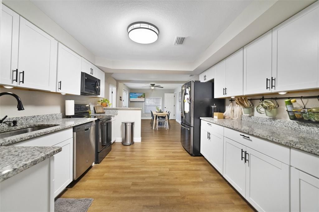 The family chef will be delighted to find the galley style kitchen is well equipped with granite countertops, STAINLESS STEEL APPLIANCES, and modern cabinetry in the shaker style.