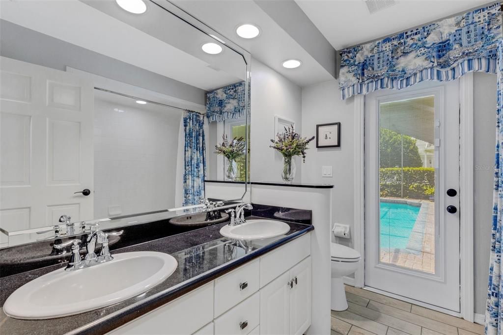 Tucked into this wing is also a full bathroom with direct access to the pool and lanai.