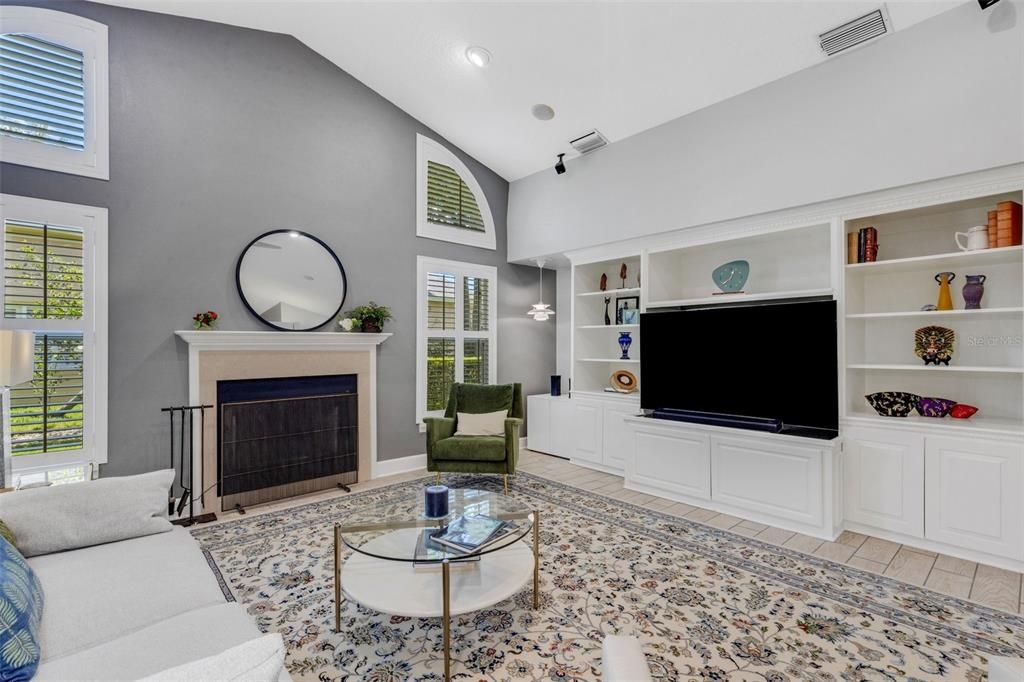 The adjacent oversized family room has a centrally located fireplace without the TV fighting for wall space courtesy of the built-in entertainment center.