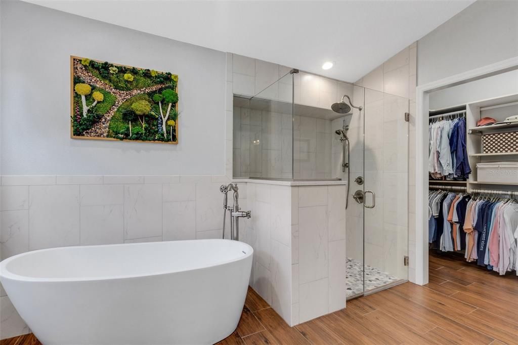 A floating tub and oversized glass enclosed shower