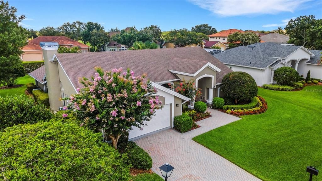 A full brick paver driveway and front walkway add elegance to the entire setting