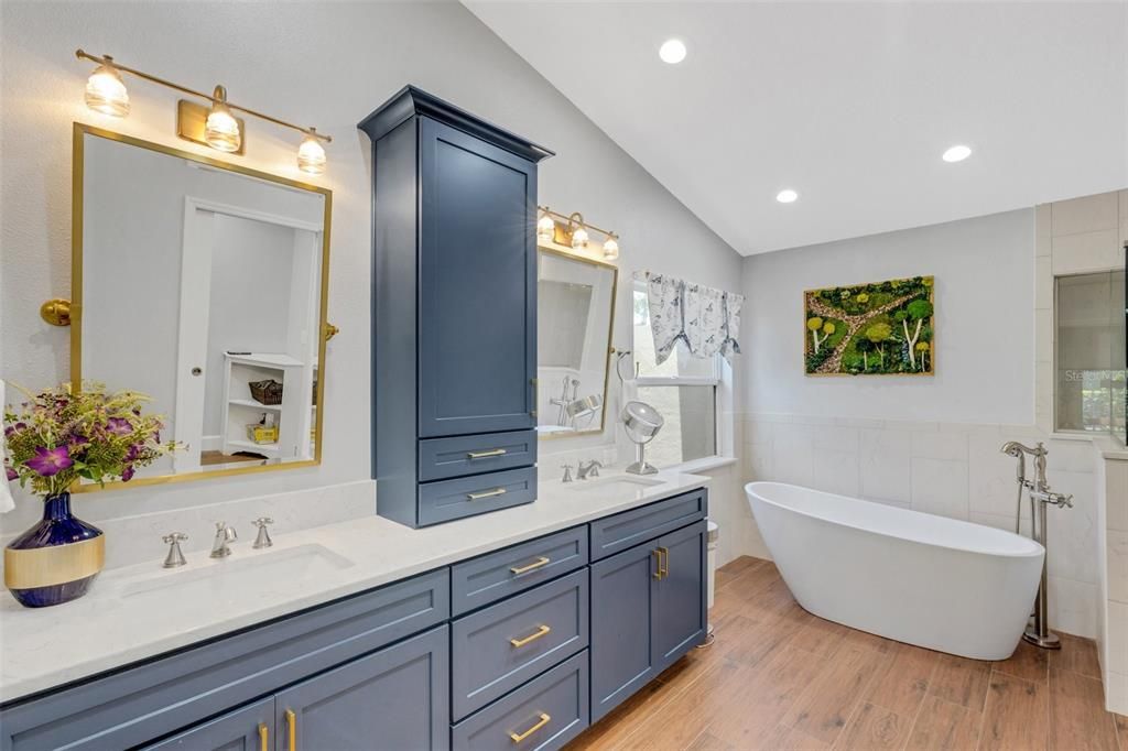 The en-suite bathroom was completely remodeled in recent years with all new vanity cabinets in a vibrant blue