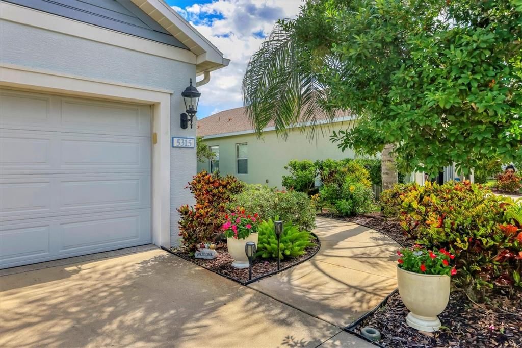 Entrance way to front door features a mature landscaped walkway for the ultimate curb appeal