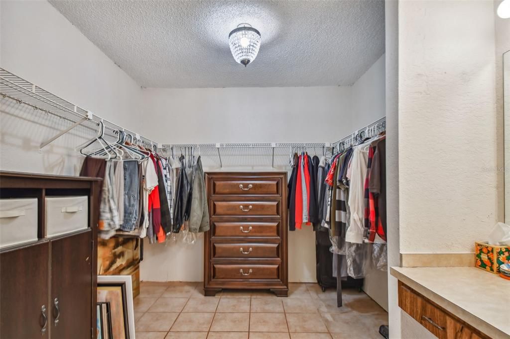 Massive walk-in dressing closet in primary bedroom