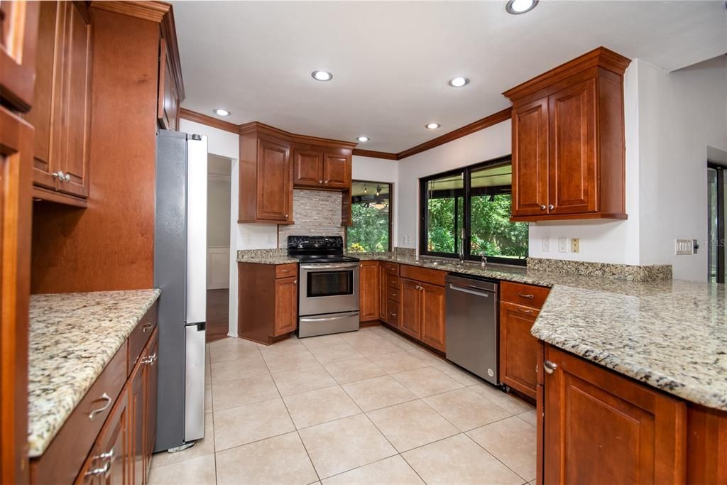 Bright Kitchen with solid Wood Cabinets and Stone Countertops