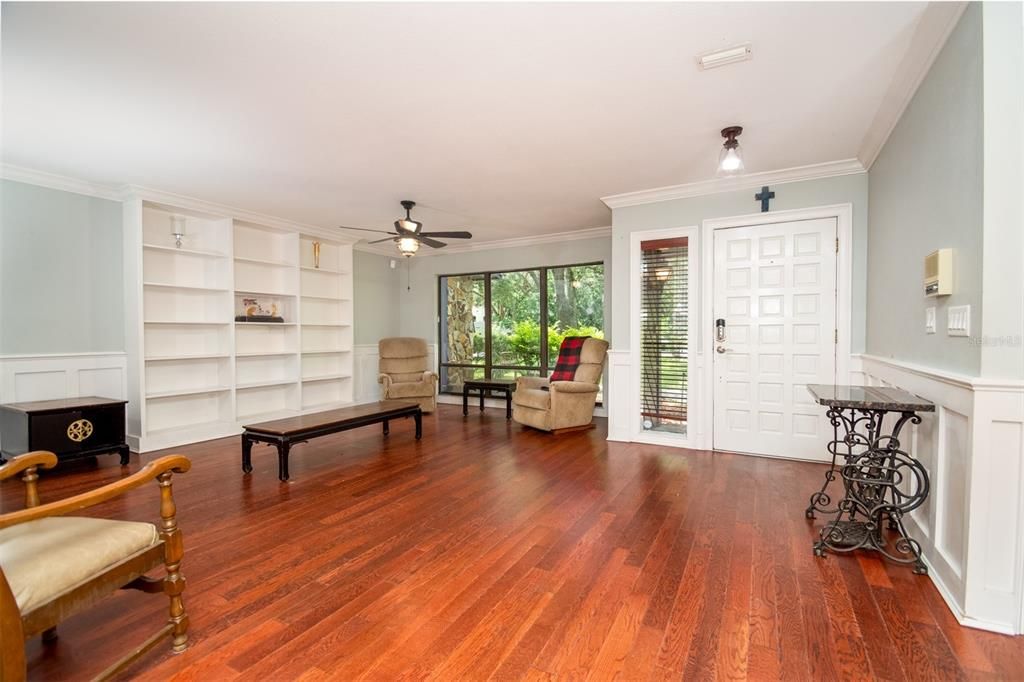 Front Room with Built in Shelving and Large and Bright Window.