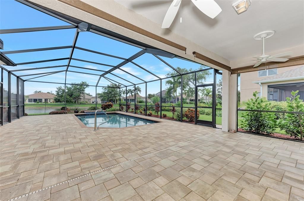 Covered lanai with roll down solar shades and cooled by ceiling fans.