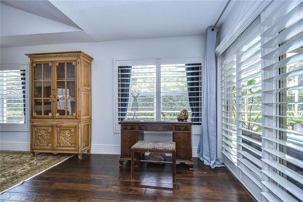 Primary suite sitting area overlooking lanai and pool