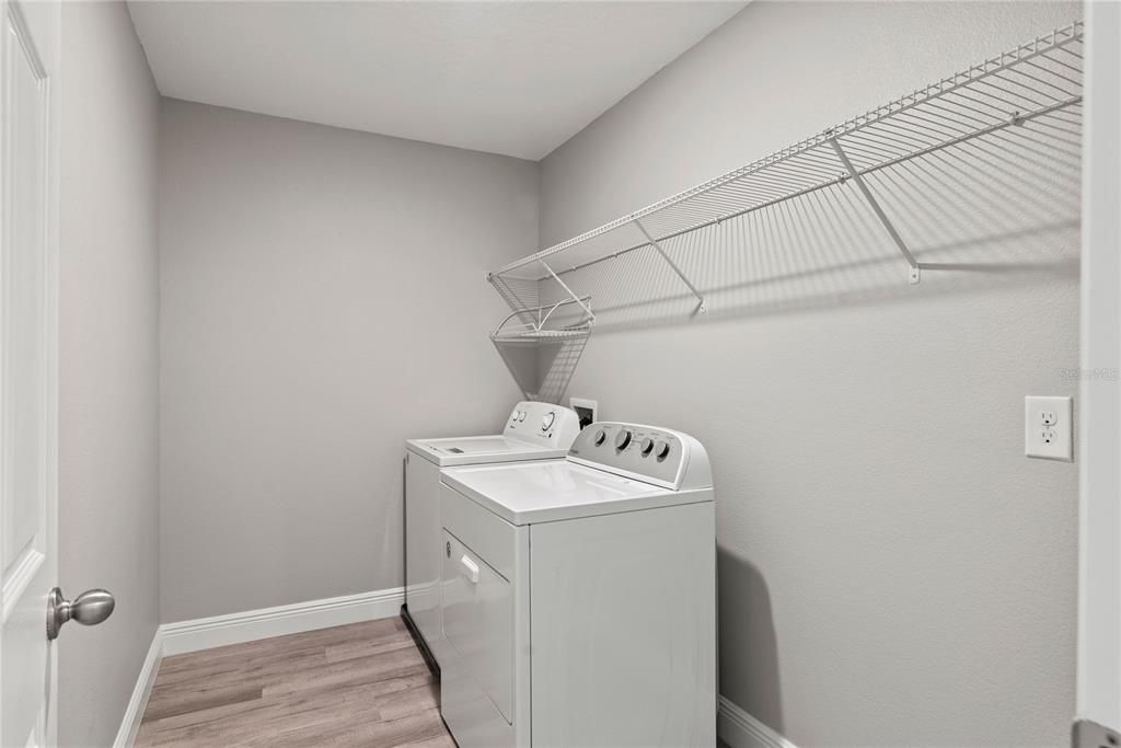 Upstairs laundry room for convenience and functionality with washer and dryer included