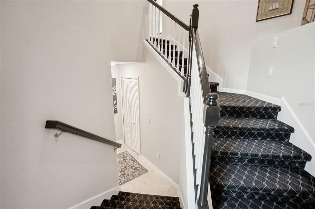 Plush carpeting on the stairs and a painted railing takes you up to your main living area.